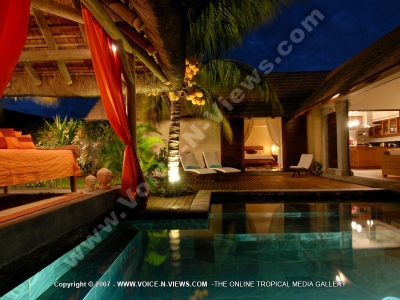 general view of the two bedroom villa pool and its sunbeds
