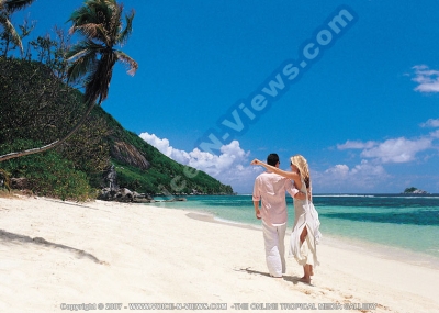 sainte anne resort seychelles couple going for a walk on the  beach
