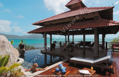 sainte anne resort seychelles lady-erlaxing in villa royale swimming pool
