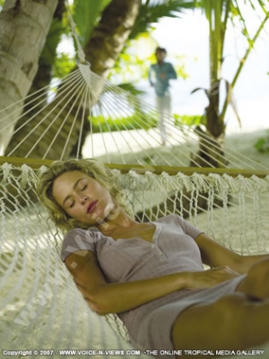 sainte anne resort seychelles lady relaxing in hammock
